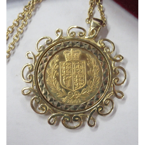 222 - A gold half sovereign, in gold pierced frame and with chain, total weight 10.7g