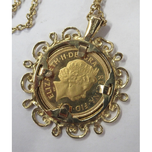 222 - A gold half sovereign, in gold pierced frame and with chain, total weight 10.7g