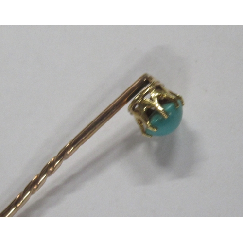 225 - A gold stick pin, set with a turquoise