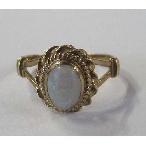 228 - A 9ct gold ring, set with an opal, weight 1.7g