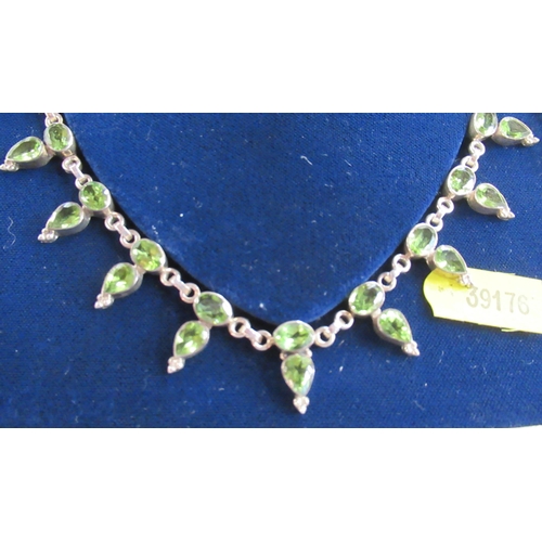 231 - A jewellery suite, comprising necklace, bracelet and earrings, all set with green stones in silver, ... 