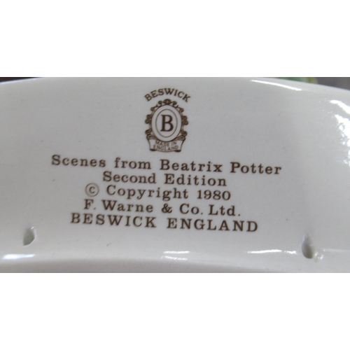 255 - A Beswick stand, for figures, together with three Beswick Beatrice Potter scene plates
