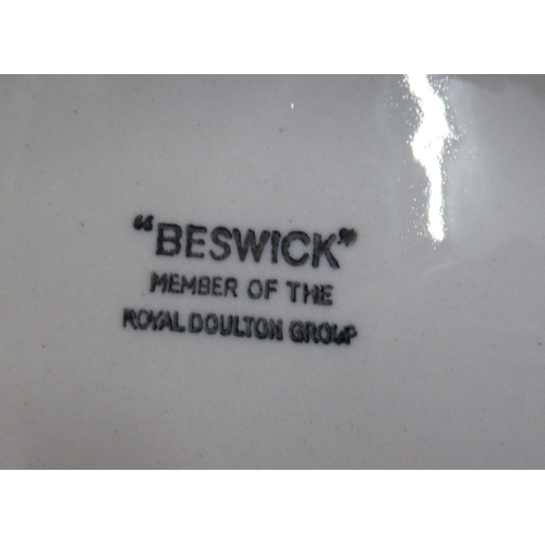 255 - A Beswick stand, for figures, together with three Beswick Beatrice Potter scene plates