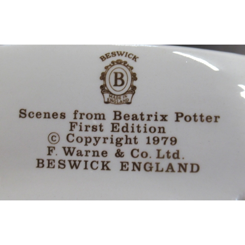 255 - A Beswick stand, for figures, together with three Beswick Beatrice Potter scene plates