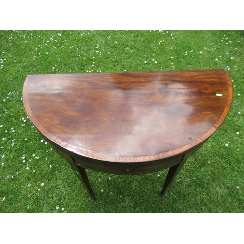 31 - A late Georgian mahogany half round fold over tea table diameter 40ins