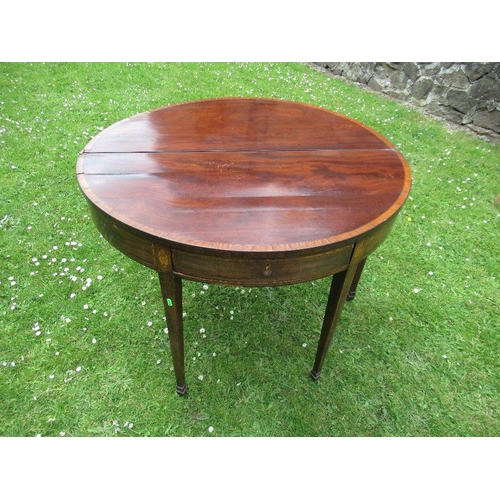 31 - A late Georgian mahogany half round fold over tea table diameter 40ins