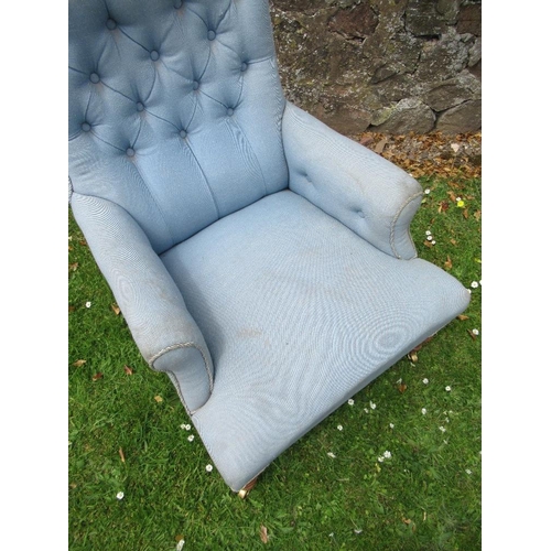 43 - An Howard style arm chair raised on turned wooden legs