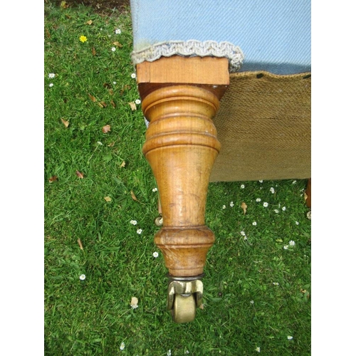 43 - An Howard style arm chair raised on turned wooden legs