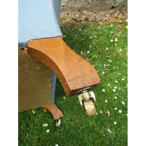 43 - An Howard style arm chair raised on turned wooden legs