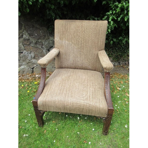 55 - A Georgian style armchair with acanthus carving to an open arm with blind fret carving to the legs