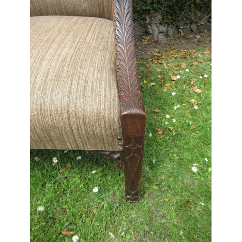 55 - A Georgian style armchair with acanthus carving to an open arm with blind fret carving to the legs