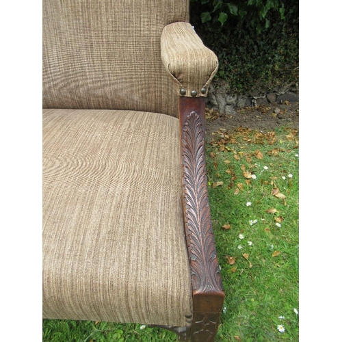 55 - A Georgian style armchair with acanthus carving to an open arm with blind fret carving to the legs