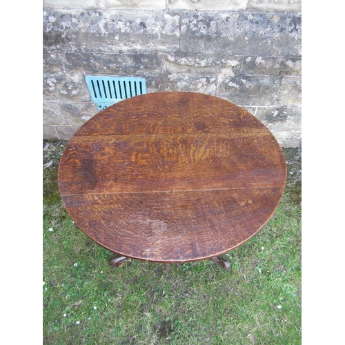 57 - An Antique oak tripod table, diameter 31ins, height 28ins
