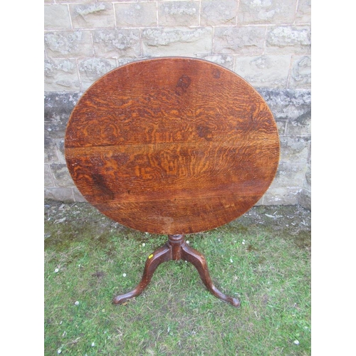 57 - An Antique oak tripod table, diameter 31ins, height 28ins