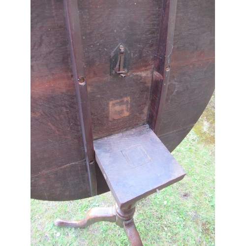 57 - An Antique oak tripod table, diameter 31ins, height 28ins