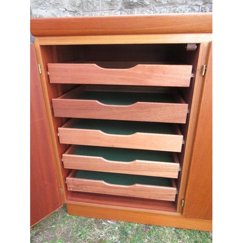 62 - A Danish Skovby sideboard, fitted with four cupboard doors, opening to reveal shelves and drawers, w... 