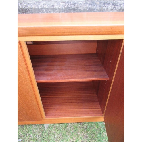 62 - A Danish Skovby sideboard, fitted with four cupboard doors, opening to reveal shelves and drawers, w... 