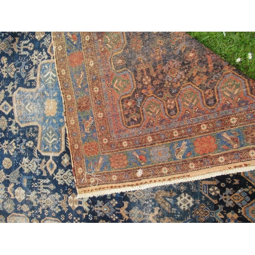 68 - An Eastern design carpet with a central blue field having a central foliage cross  76in x 58ins