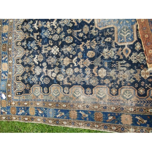 68 - An Eastern design carpet with a central blue field having a central foliage cross  76in x 58ins
