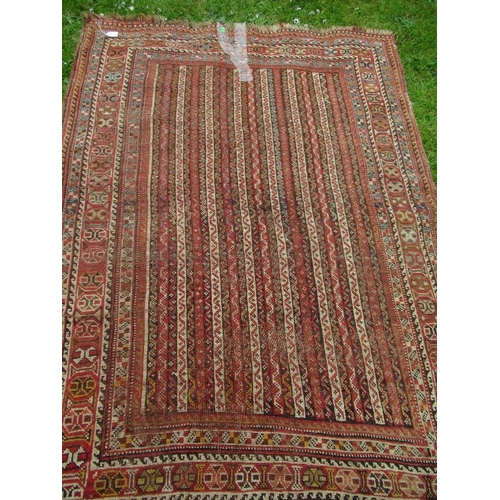 69 - An Eastern design carpet, with a red and beige ground with line field and a repeating boarder, 70ins... 