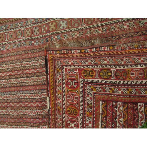 69 - An Eastern design carpet, with a red and beige ground with line field and a repeating boarder, 70ins... 