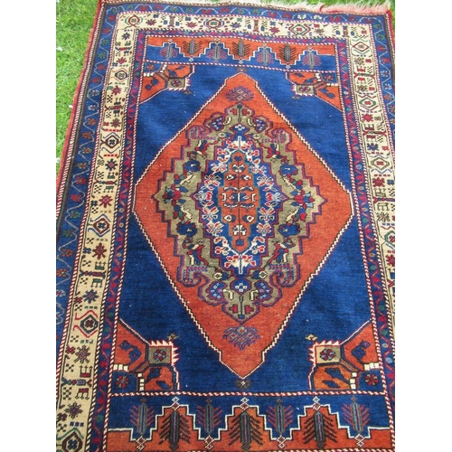 73 - An Eastern rug with a blue field having central design and stylized decoration 69ins x 47ins