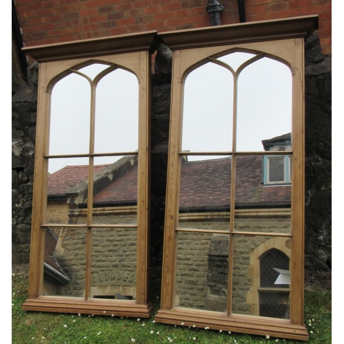 77 - A pair of pine framed ecclesiastical style mirrors, 61.5ins x 33ins