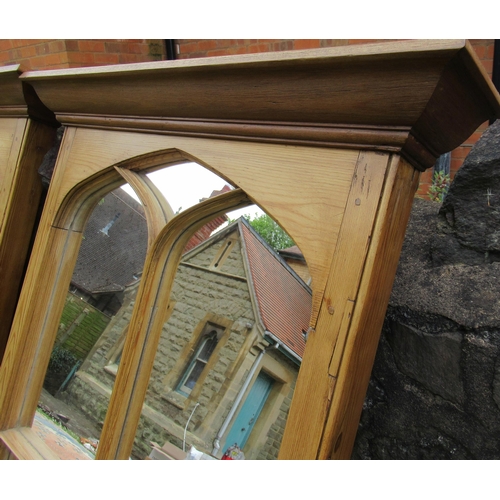 77 - A pair of pine framed ecclesiastical style mirrors, 61.5ins x 33ins