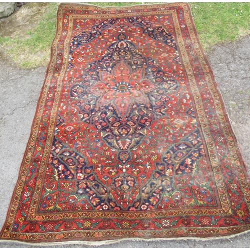 79 - A rug, decorated in blue and red, 78ins x 50ins