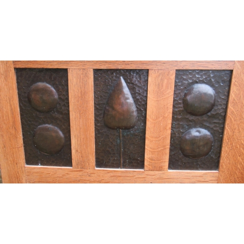 84 - An Arts and Crafts style oak coffer, set with beaten copper panels, 25ins x 16.5ins, height 17.5ins