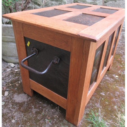 84 - An Arts and Crafts style oak coffer, set with beaten copper panels, 25ins x 16.5ins, height 17.5ins