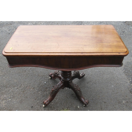 88 - A Victorian fold over tea table, raised on carved legs