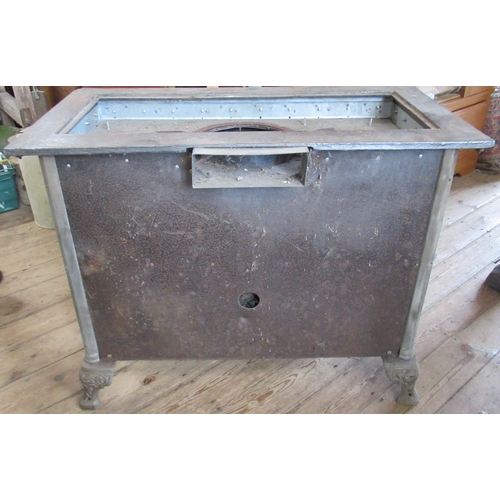 94 - A French cast iron stove, decorated with tiles, with cooking plates to the top, oven to the front an... 