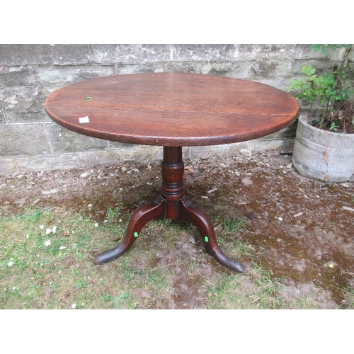 64 - A 19th century oak tripod table 32ins diameter height 26ins