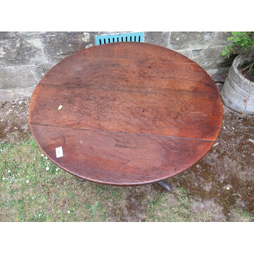 64 - A 19th century oak tripod table 32ins diameter height 26ins