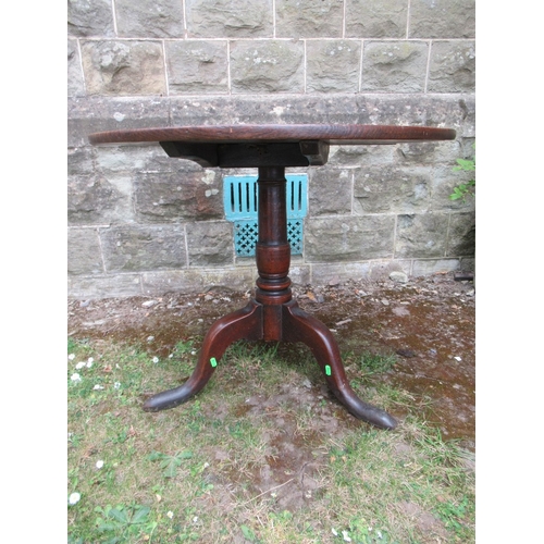 64 - A 19th century oak tripod table 32ins diameter height 26ins