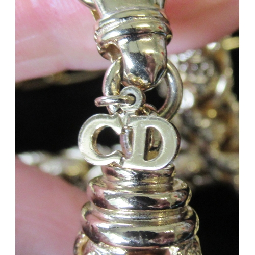 243A - Two Dior necklaces, together with others, in display cases