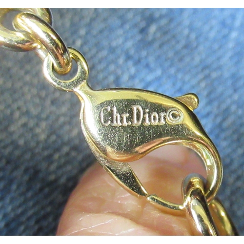 243A - Two Dior necklaces, together with others, in display cases