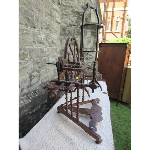 10 - (43) A small antique spinning wheel with bobbin turned supports raised on a triangular base, height ... 