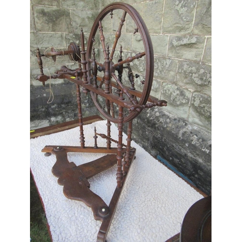 10 - (43) A small antique spinning wheel with bobbin turned supports raised on a triangular base, height ... 