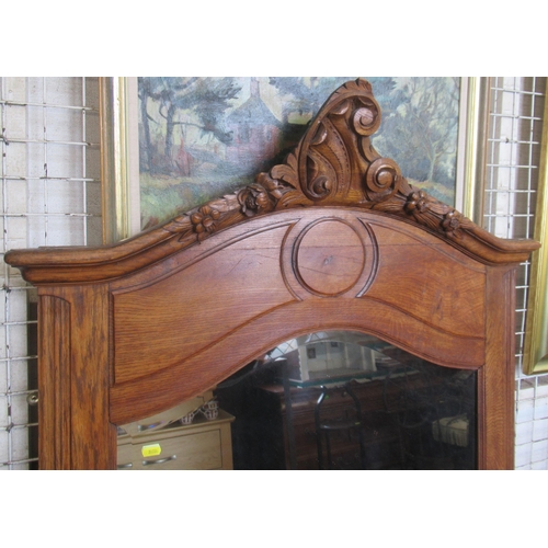 177 - A large wooden framed wall mirror, with carved decoration, overall 66ins x 36ins