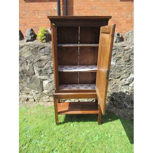 18 - (56) An antique oak cupboard with panel door to reveal two shelves and raised on a stand , width 26i... 