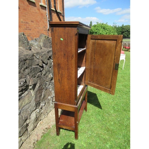 18 - (56) An antique oak cupboard with panel door to reveal two shelves and raised on a stand , width 26i... 