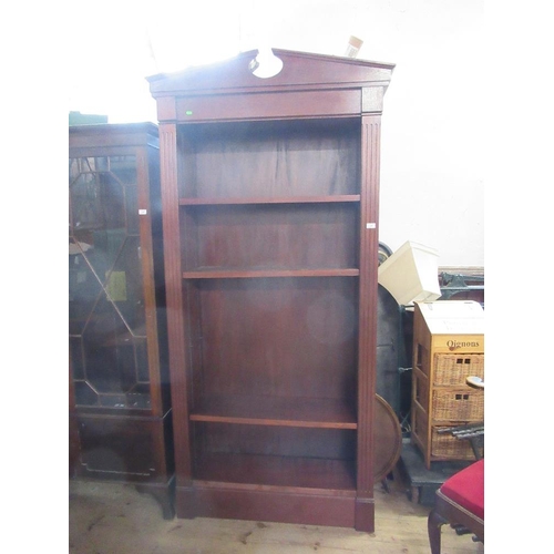 24 - A 19th century design mahogany set of shelves, having broken arch pediment, over adjustable shelves,... 