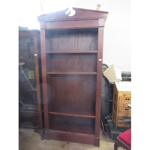 24 - A 19th century design mahogany set of shelves, having broken arch pediment, over adjustable shelves,... 