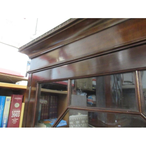 27 - A mahogany glazed cabinet, with astragal glazed doors, opening to reveal adjustable shelves, over tw... 