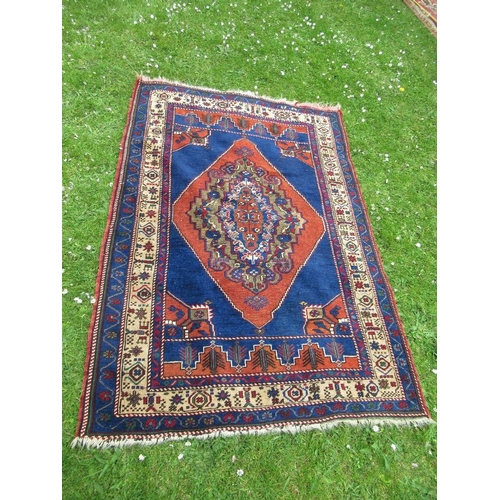 29 - An Eastern rug with a blue field having central design and stylized decoration 69ins x 47ins