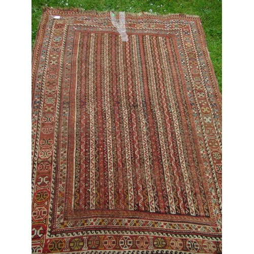 30 - An Eastern design carpet, with a red and beige ground with line field and a repeating boarder, 70ins... 