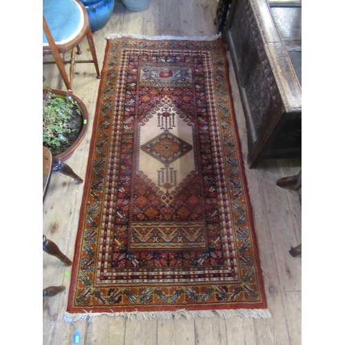 31A - An Eastern design rug, 74ins x 36ins