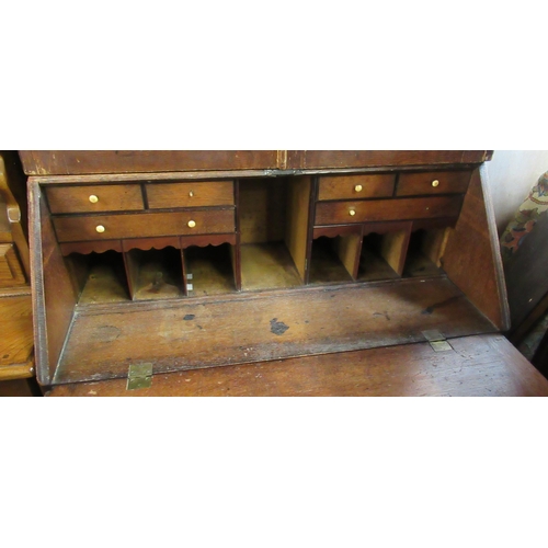 32 - A Georgian oak bureau, the sloping fall front fitted with drawers and pigeon holes, with long drawer... 